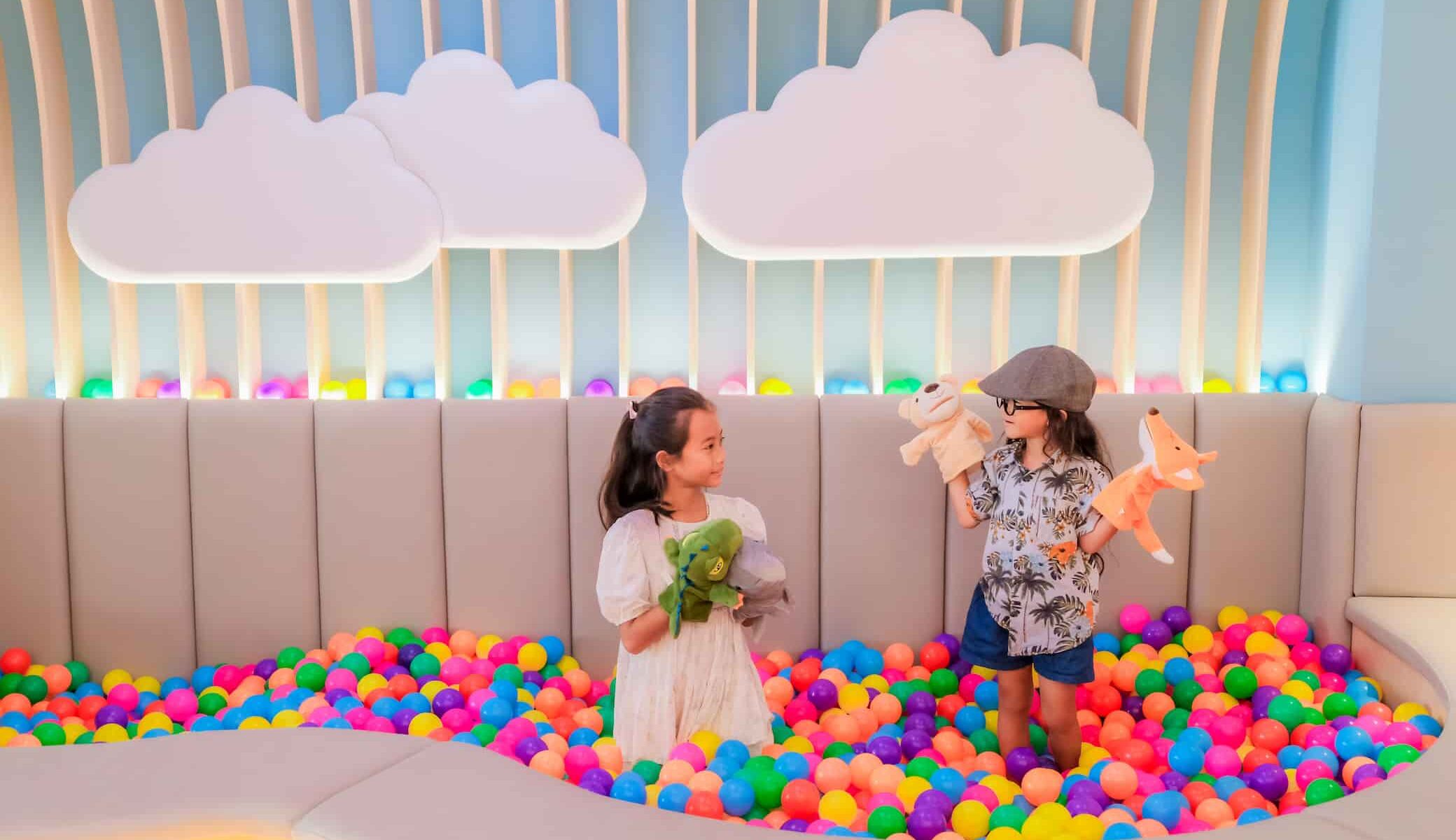 Children enjoy fun activities at the hotel's Kids Club with a ball pit, games, and reading corner.