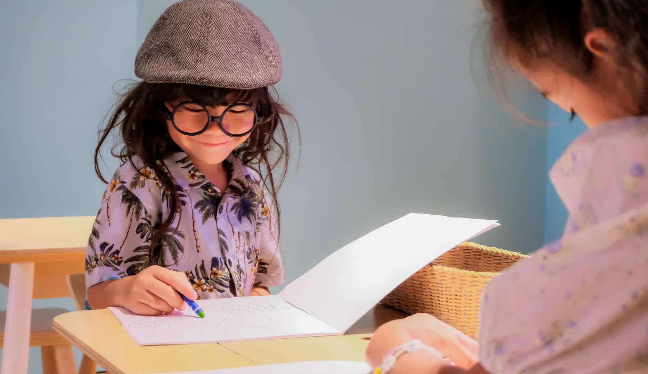 Child enjoying a coloring book activity at the hotel kids club.