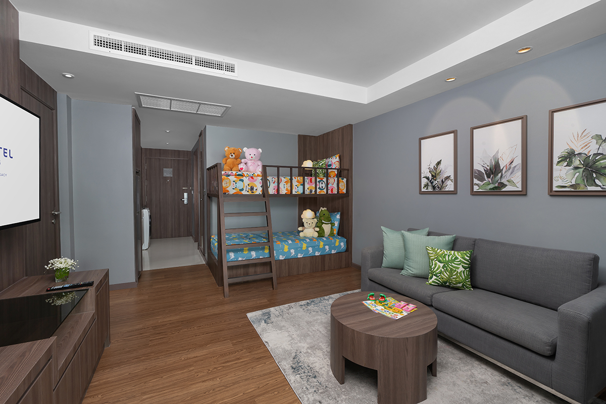 Modern family hotel suite with bunk bed and cozy amenities for kids