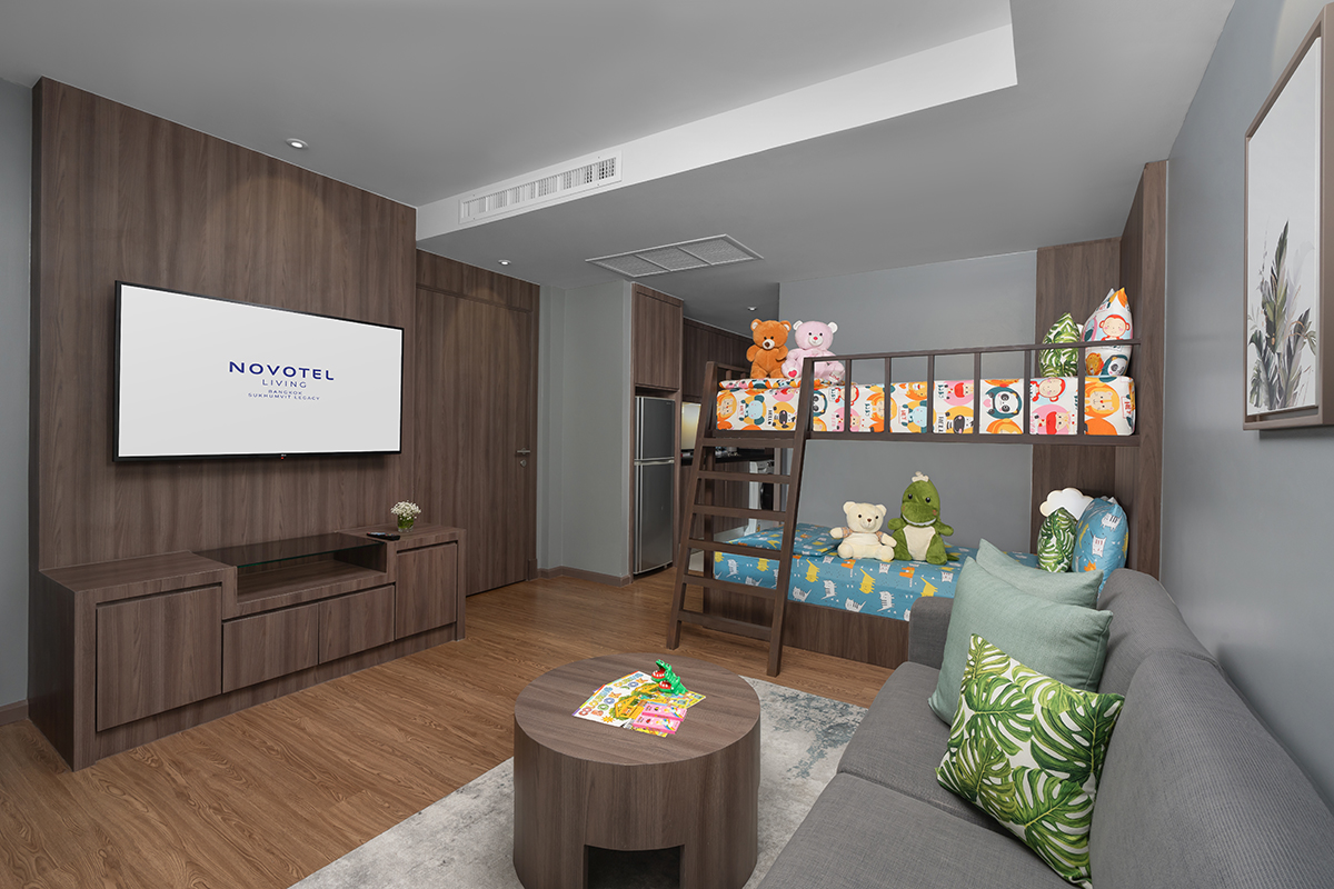 Modern family hotel suite with bunk bed and cozy amenities for kids